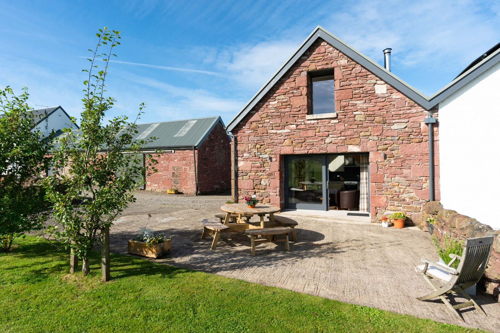 Large sliding doors open to the patio & lawn
