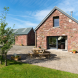 Large sliding doors open to the patio & lawn